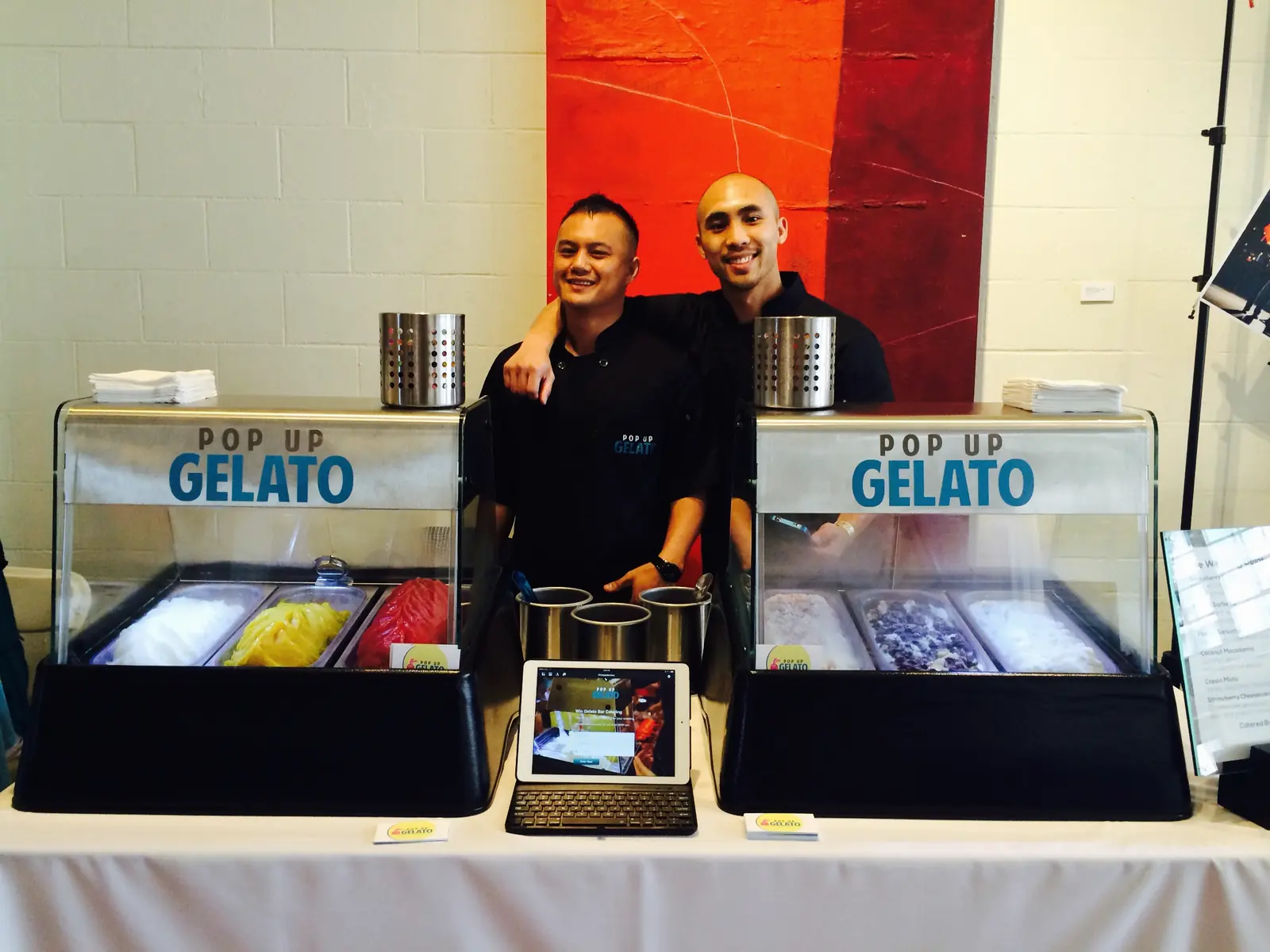 Marvin and a Pop Up Gelato co-founder behind two tabletop gelato stations at a wedding fair, 2014
